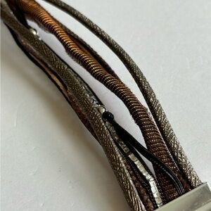 Magnetic bracelet/ made of varied types of fabric & leather/ measures 7.5 inches